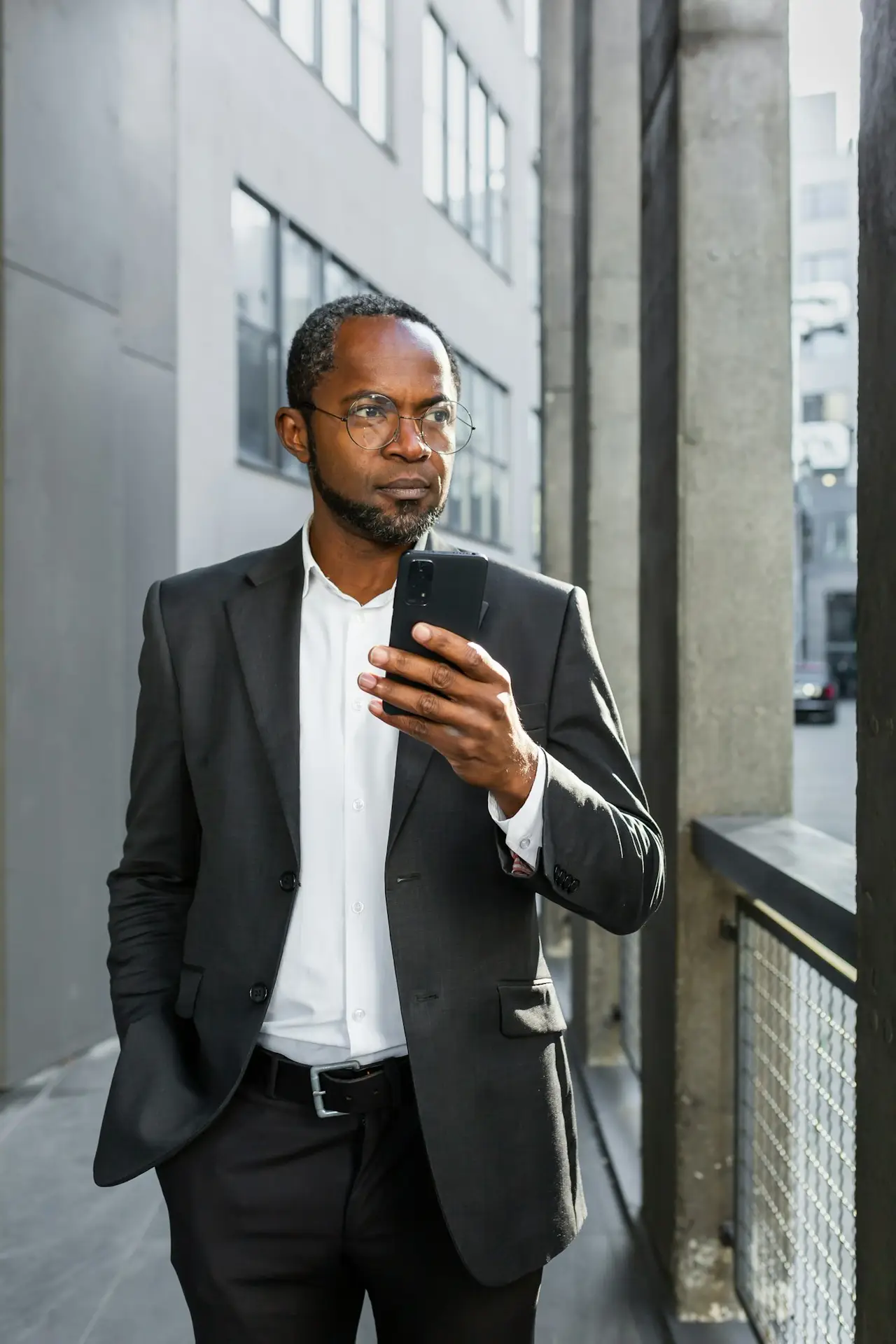 Portrait of a successful senior African-American businessman, lawyer, banker standing near a